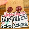 Close-up of wooden school earrings with pink sequins held on a jewelry card - Happy FIRST DAY-Glitter Stud