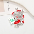 Detail of cartoon dragon brooch with white rhinestones and red enamel decoration - Dragon Fortune - Silver