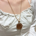 Detail of bohemian hand-woven wooden bead pendant on a brown cord necklace - Brown Wood Bead Woven Disc Necklace (DZ-306)