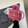 Pink faux fur crossbody bag with leather strap and silver zipper in a lifestyle setting - No Pendant / Rose Pink