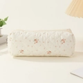 Close-up of beige quilted cotton floral pouch with zipper and delicate flower pattern - White Floral