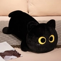 Close-up of black plush cat toy with large yellow eyes on soft bedroom bedding - 50cm / Black Cat
