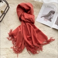 Solid coral red thick cashmere-feel scarf with tassels on plush background - Concubine Red