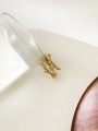 Detailed close-up of golden lava texture ring with two zircon stones on stone background - Branch Rhinestone