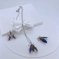 Detailed jewelry set with insect pendants featuring blue zircon on a white gift box - #3 Silver Insect Set with Blue & Brown Stones