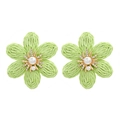 Macro detail of hand-woven green raffia flower earrings with pearls and crystals - Green