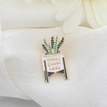 Enamel plant pot brooch with 'Crazy Plant Lady' text in a minimalist floral setting - Text Plant Pot (C1827-1)
