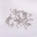Polished silver metal beads for DIY jewelry making scattered on white fabric - White Gold Plated 2mm