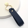 Navy blue leather keychain with golden heart pendant engraved with He is love text - Dark Blue