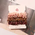 Close-up of 4-piece satin scrunchies set in pink and bronze tones on a display card - Snow Ivory Champagne Gold Coffee