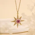 Detail of gold starburst pendant with a pink evil eye and sparkling zircon stones - Pink Star-B3