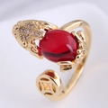 Macro shot of gold frog ring with red zircon and copper coin detail - Gold Money Toad
