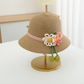 Detail of children's straw hat featuring pink polka dot ribbon and 3D fabric flowers - Straw Hat / Khaki