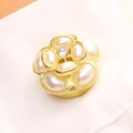 Detail of camellia flower buckle with white petals and crystal center on white fabric - 14K Gold Pearl Camellia Style (3777)