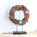 Christmas wreath ornament with pine cones and red berries on a 40cm metal stand - Pine Cone Wreath with Metal Stand / Approx. 40CM