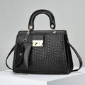 Close-up of black woven leather handbag with gold metal clasp and small pendant bag - Black