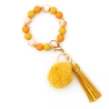 Silicone bead keychain bracelet in yellow and marble tones with fur pompom and tassel - Yellow