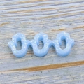 Detailed view of three blue Hamsa hand resin pendants with sparkling opal finish - Sky Blue