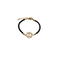 Religious woven bracelet with gold-toned charms and cubic zirconia on a white background - Black Braided Rope