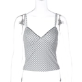 Detail showing white fabric with black polka dots and V-neckline of a slim camisole top - S / White