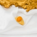 Minimalist 18k gold plated ring with oval amber gemstone on white silk background - Topaz