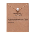 Minimalist gold necklace with white pearl pendant displayed on brown card packaging - Gold Pearl Pendant Necklace (NC18Y0037-1)