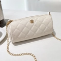 Beige quilted cylinder bucket bag with golden camellia hardware and chain strap - White