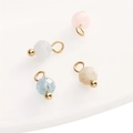 Faceted natural stone pendants in pink, blue, and white with golden metal ring loops - Morganite