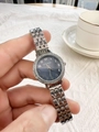 Close-up of silver metal ladies watch featuring a dark blue dial with rhinestone bezel - Silver Blue Dial