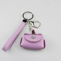 Detail view of a purple PU leather mini coin purse keychain with wrist strap - Violet