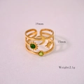 Detail view of adjustable gold ring featuring sun, moon, star motifs and green stones - Green Agate