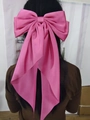 Pink satin bow hair clip with long streamers shown as a rear-view hair accessory - Rose Pink