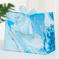 Blue marble gift bag with gold foil patterns and a blue satin bow for special events - Blue Ocean