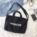 Black canvas tote bag with white Heymister lettering and adjustable shoulder strap - Black
