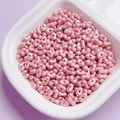Macro detail of pink pearlescent double-hole oval beads for DIY jewelry making accessories - Pink Purple
