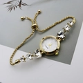 Close-up of gold chain watch band featuring heart-shaped rhinestones and sliding clasp - Gold White