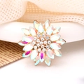 Macro detail of sun flower alloy accessory with iridescent petals and clear rhinestones - AB Color