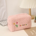 Pink plush tulip makeup bag with Sunshine embroidery on a cozy desktop scene - Pink