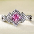 Macro shot of silver ring with pink princess cut stone and infinity twist diamond band - Ur0683