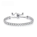 Detail of silver adjustable tennis bracelet featuring a sliding clasp and round clear crystals - Silver - White Zirconia