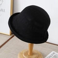 Detail of black textured cotton bucket hat with rolled brim on a wooden stand - M (56-58cm) / Black