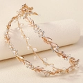 Detail of gold bridal headband with white pearls and crystal flower leaves on a beige stand - Gold Pearl Rhinestone
