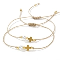 Adjustable woven bracelet set with white pearl and gold cross pendant on white background - Heart and Cross 2-Piece Set
