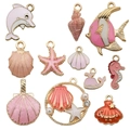 Assorted gold-tone ocean-themed enamel charms including starfish and shells for DIY jewelry - Mix 12pcs Pink Series