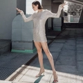 Dynamic outdoor shot of a shimmering sequin mini dress with long sleeves and slim fit - S / Silver