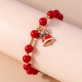 Detail of red Christmas beaded bracelet featuring a festive gold bell with a tiny rhinestone - Red Beads-Red Bell Charm