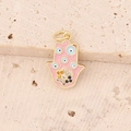 Macro view of a gold Hamsa Hand pendant with pink enamel and blue evil eye details - 10# Pink