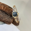Detail of a vintage gold quartz watch with black dial and leaf-shaped bracelet links - Gold Color Black