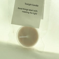 White tealight candle in transparent bag with a paper header card for gift packaging - Milk Tea (Amber Ebony)
