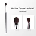 Medium eyeshadow brush made with pony hair featuring a sleek black handle and silver ferrule - Medium Eyeshadow Brush (Pony Hair)